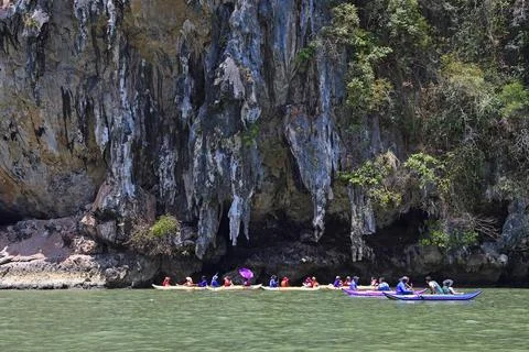 Tourists explore eroded limestone cliffs by canoe in Phang Nga Bay Thailand Asia 스톡 사진