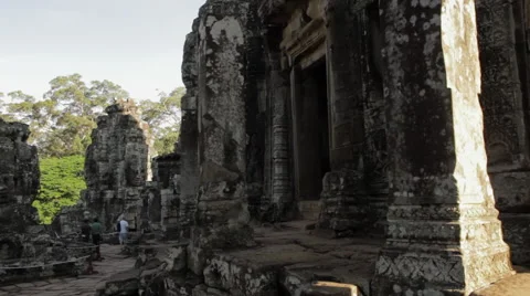 Tourists explore head carvings on pillars, Bayon Temple Stock Footage 42468166