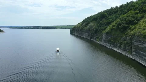 Tourists explore the river in the highlands while relaxing on a white boat Stock Footage 163670297