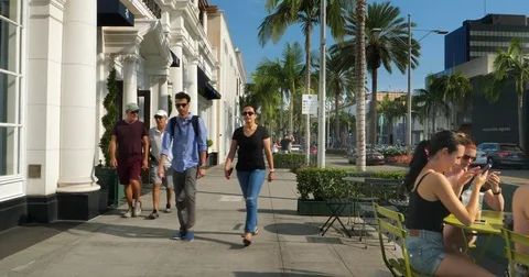 Tourists explore Rodeo Drive in Beverly Hills, Los Angeles, California, 4K Stock Footage 81645241