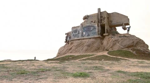 Tourists exploring abandoned cliff side house Stock Footage 66777660
