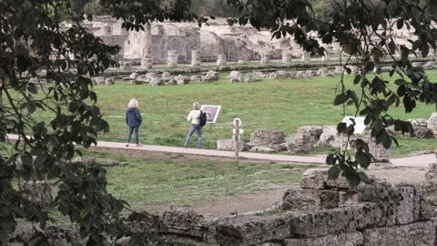 Tourists exploring ancient Greek temples ruins of Paestum in southern Italy Stock Footage 319776899