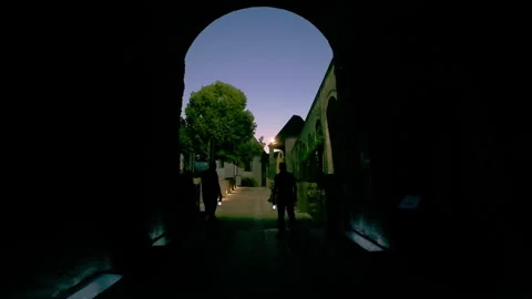 Tourists exploring an ancient stone village by lantern light in the evening Stock Footage 346239454