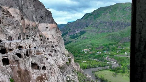 Tourists exploring the ancient vardzia cave monastery in georgia Stock Footage 339173670