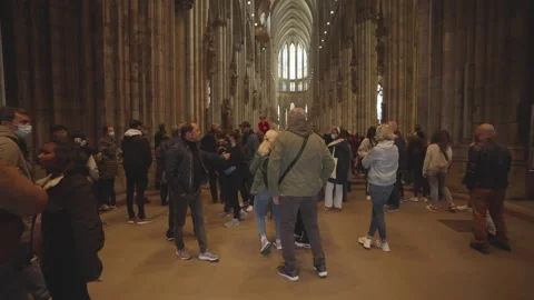 Tourists exploring and pray at the Cologne Cathedral Stock Footage 325090384