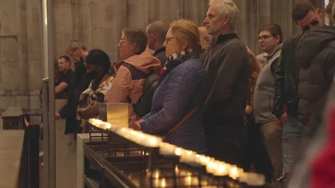 Tourists exploring and pray at the Cologne Cathedral Stock Footage 325102415