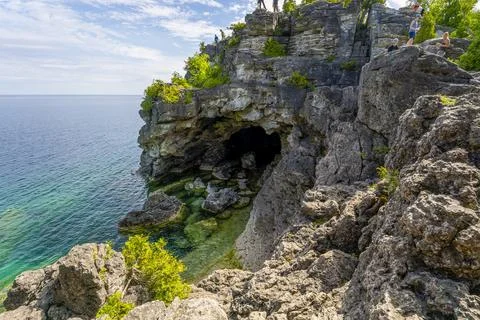 Tourists Exploring the Grotto Cliffs Stock Photos