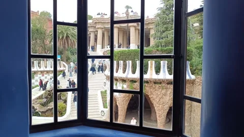 Tourists exploring the hypostyle room and stairway in Park Guell Stock Footage 328193496