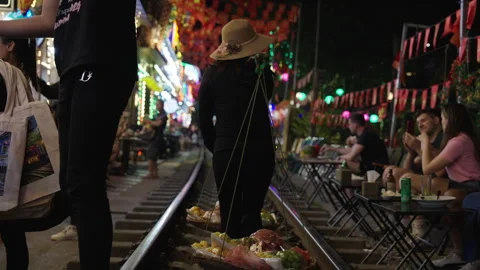 Tourists Exploring the Iconic Hanoi Train Street at Night. Stock Footage 323767768