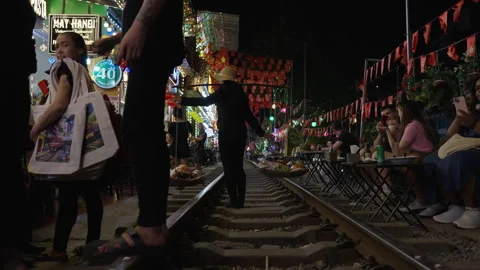 Tourists Exploring the Iconic Hanoi Train Street at Night. Stock Footage 323767809