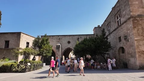 Tourists Exploring Palace Square in Rhodes Old Town Stock Footage 340575973