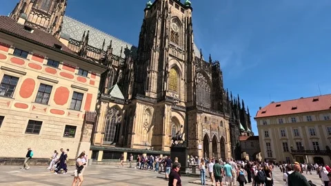 Tourists Exploring St. Vitus Cathedral’s Gothic Facade at Prague Castle on Stock Footage 346965195