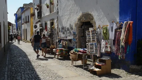 Tourists exploring tourist shops in the Old Town of Obidos, Portugal Stock Footage 95811902