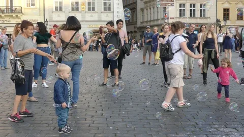Tourists in flying soap bubbles in the Old Town Square of Prague. Stock Footage 92198796