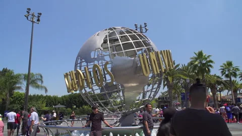Tourists in front of the rotating globe at Universal Studios Hollywood Stock Footage 194123710