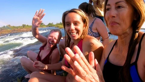 Tourists gather at Devil's Pool, the edge of Victoria Falls, Zambia for a Stock Footage 113200839