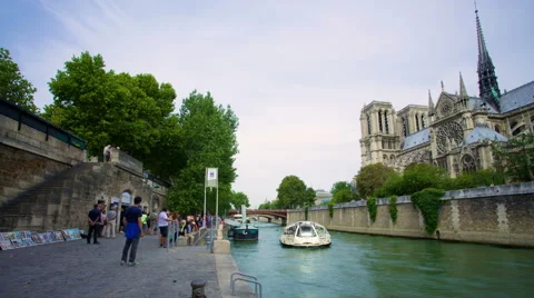 Tourists getting off a boat after docking next to the Notre Dame Stock Footage 40178102
