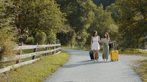 Tourists girlfriends with suitcases using paper map Stock Footage 119860197