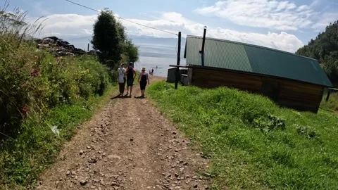 Tourists go down the path to Lake Baikal Stock Footage 254100146