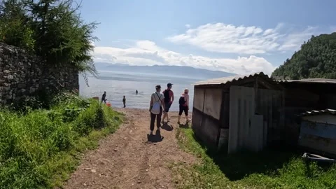 Tourists go down the path to Lake Baikal Stock Footage 254100367