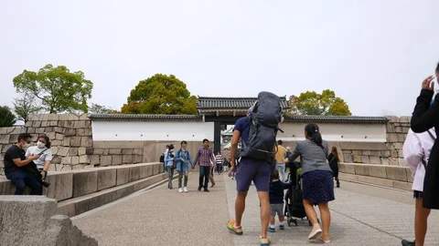 Tourists go to Osaka Castle through entrance, Japen Stock Footage 90563359
