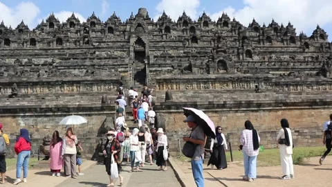 Tourists on the grounds of Borobudur Temple, Java, Indonesia. Stock Footage 245264736