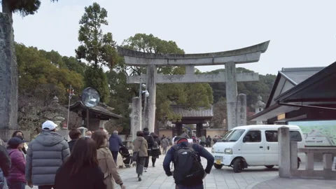 Tourists group walking behind their guide in Japanese Dazaifu shrine. Stock Footage 247655873