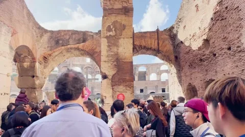 Tourists on a guided tour eagerly awaiting entry to the Roman Colosseum Stock Footage 262581849
