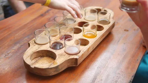 Tourists hands during degustating various exotic drinks at kopi luwak farm, Bali Stock Footage 188243902