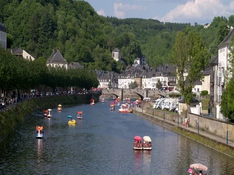 Tourists having fun on pedalos on the Semois river in the city of Bouillon Stock Footage 76236192
