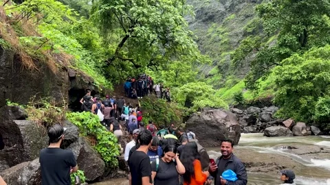 Tourists hiking on a crowded mountain trail during monsoon season in India Stock Footage 340252124
