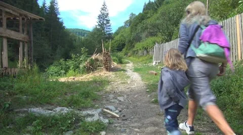 Tourists Hiking in Mountains, Mother and Child Climbing, People Walking on Path Stock Footage