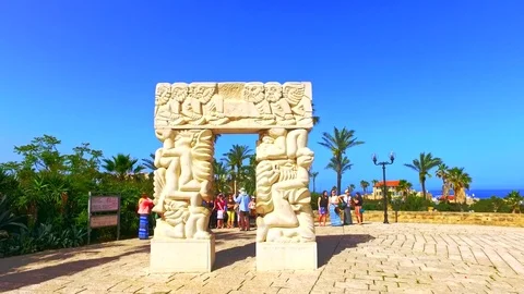 Tourists by Iconic installation on beach of Tel Aviv by Mediterranean sea Stock Footage 73607409