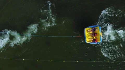 Tourists on an inflatable sofa in life jackets return to the shore Video stock 201066128