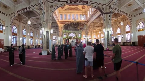 Tourists inside El Mina Mosque, Hurghada, Egypt, standing in a grand prayer Stock Footage 333411673