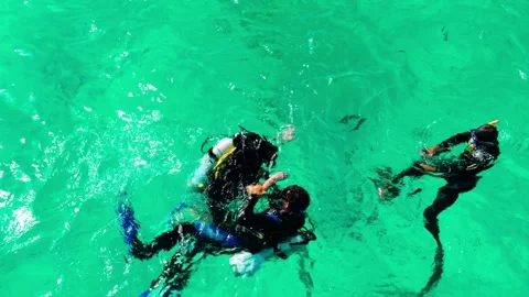 Tourists with an instructor scuba dive in the Red Sea over a coral reef. Stock Footage 324896459