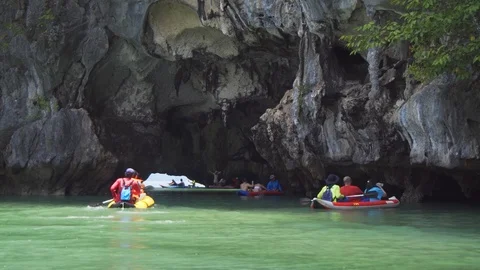 Tourists kayaking near the limestone cliffs in Phang Nga Province. Thailand Stock Footage 101859546