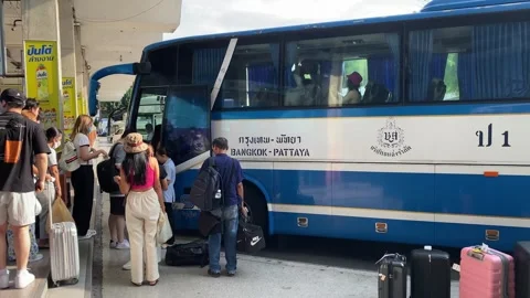 Tourists line up to board a bus heading to Pattaya beach in Bangkok, Thailand 4K Stock Footage 240462016