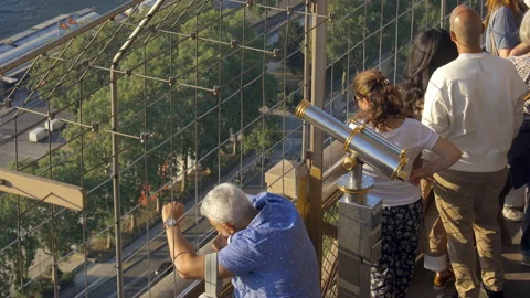 Tourists looking down at Paris while visiting the Eiffel Tower Stock Footage 197361666