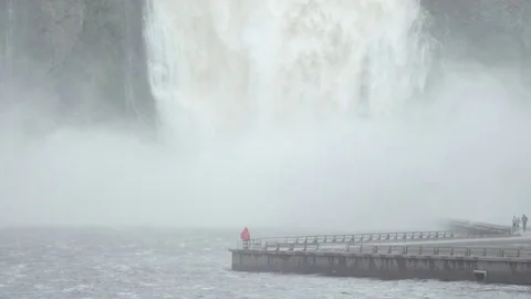 Tourists looking at huge waterfall Stock Footage 79791428