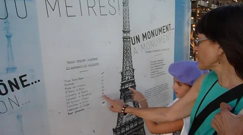 Tourists Looking at Info About Eiffel Tower Stock Footage 11882703