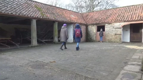 Tourists looking at an old stable Stock-Footage 88105333