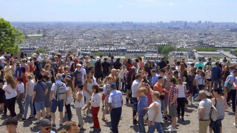 Tourists looking at the rooftops of paris from the Sacre Coeur in Montmartre Stock Footage 134259618
