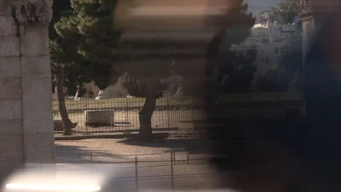 Tourists looking at the Temple of Zeus Stock-Footage 87595634