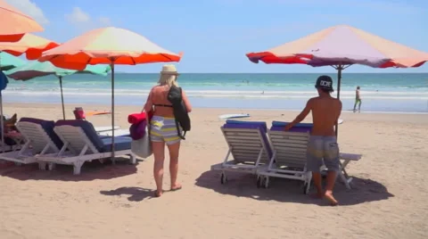 Tourists Lounge on Beach Stock Footage