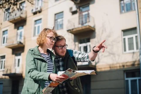 Tourists with a map on the background of the city Stock Photos