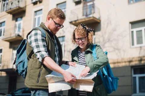 Tourists with a map on the background of the city Stock Photos