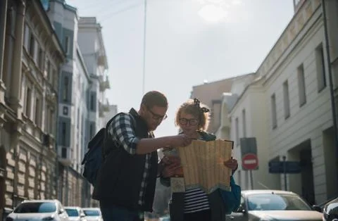 Tourists with a map on the background of the city Stock Photos