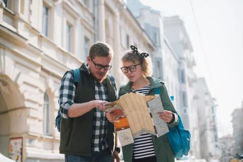 Tourists with a map on the background of the city Stock Photos