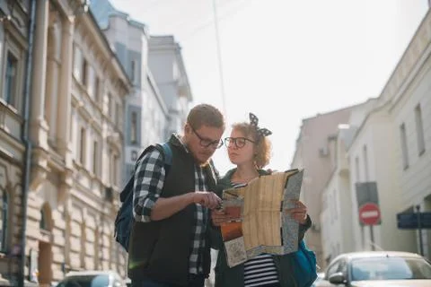 Tourists with a map on the background of the city 写真素材